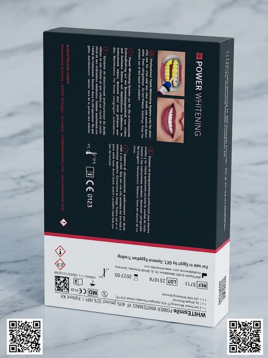 A boxed dental whitening product shown from the back of the packaging, with black upper sections, white lower sections, red accent lines, and small photos of teeth and lips. The box is photographed on a light marble-like surface with QR codes in the corners.
WHITEsmile Power Whitening YF professional in-office dental bleaching system with syringes and accessories