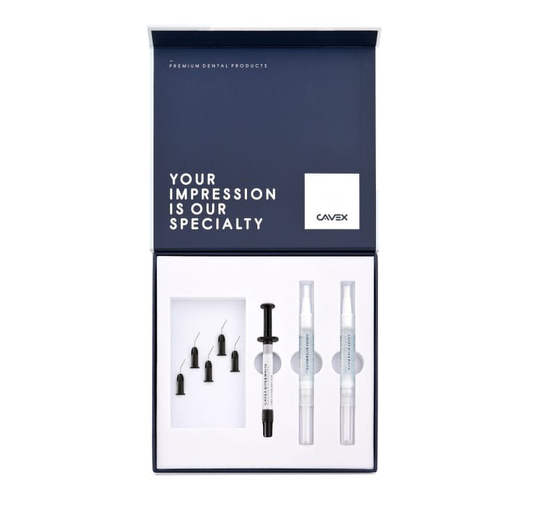 Cavex premium dental product kit in a dark navy blue and white box, containing an impression tray, impression material syringe, and two clear ampolles, shown on a plain white background.