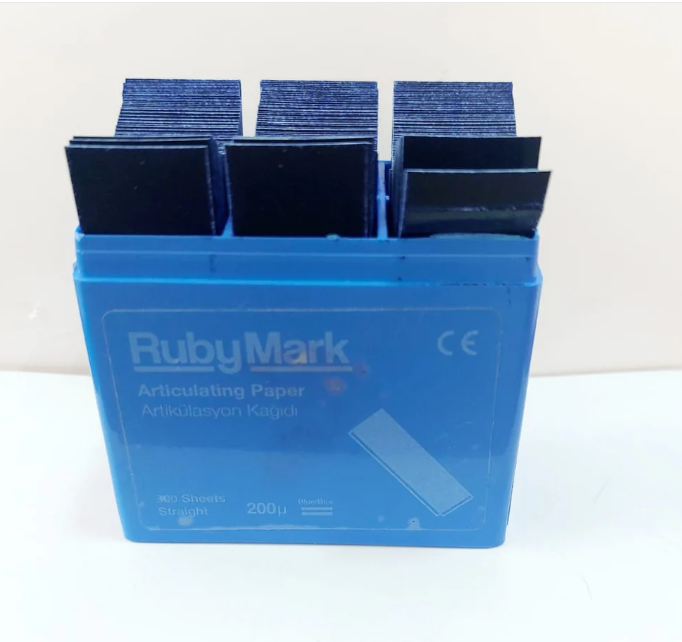 Dental articulating paper sheets used for marking occlusal contacts during bite adjustment