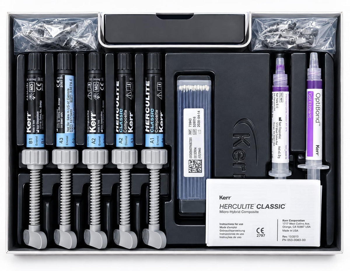 Kerr Herculite Classic micro-hybrid composite bonding kit in its black presentation box, containing four black resin syringes with blue and silver caps, four black temporary syringes with silver caps, two white adhesive syringes with purple caps, a box of blue cotton swabs, and a white instruction card.