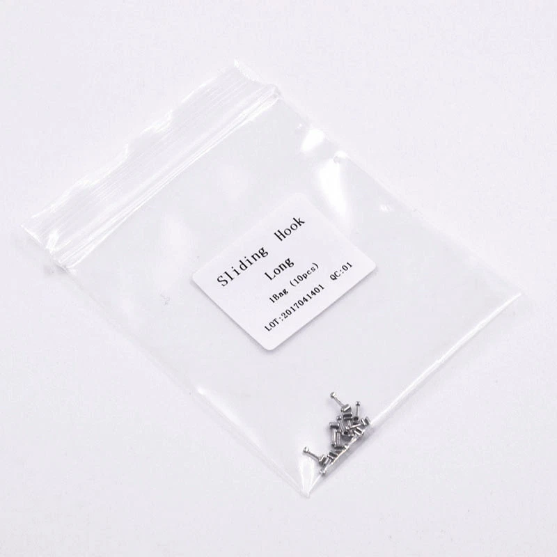 Small metal component in a clear plastic bag with a label on a white background