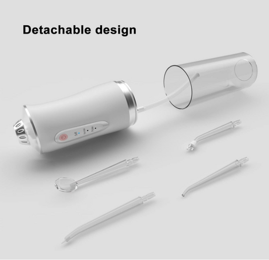 White dental tool with detachable nozzles on a light gray background